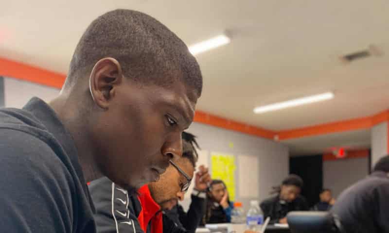 Young man looking down in classroom